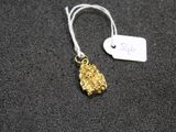 a close up of a gold nugget with a price tag on it