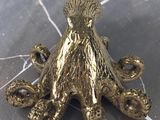 brass octopus figurine sitting on a marble surface
