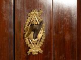 a wooden cabinet with a mirror on it in a room