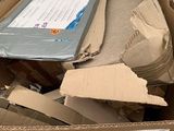 a cardboard box full of items that are sitting on top of a table