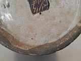 a close up of a ceramic bowl with a tag on it