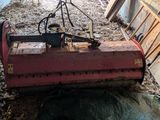a red machine that is sitting in the dirt