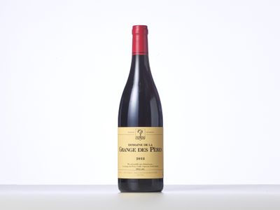a bottle of red wine sitting on top of a table