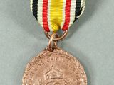 an image of a medal with a ribbon around it on a gray surface