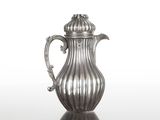 une cafetière en argent posée sur une table