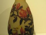 a vase with a floral design on it sitting on a table