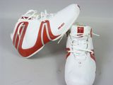 pair of red and white tennis shoes on a white surface