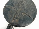 a black object with writing on it sitting on a white surface