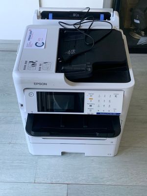 a white printer sitting on top of a stack of black and white printers