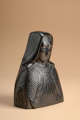 a close up of a statue of a woman wearing a black headdress