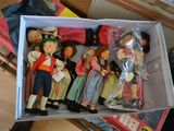 a box full of dolls sitting on top of a table