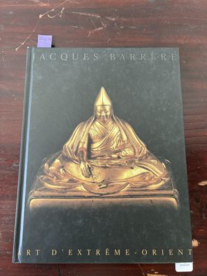 a book on a wooden table with a gold buddha statue