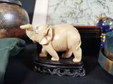 a statue of an elephant on a table next to other items