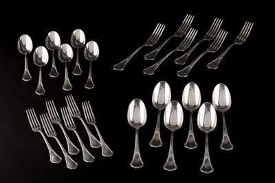 a lot of silver spoons and forks on a black background