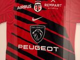 a framed picture of a red and black soccer jersey