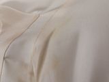 a close up of a white shirt with a button on it