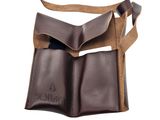 a close up of a brown leather bag with a brown strap