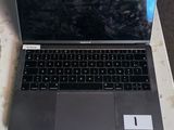 a laptop computer sitting on a table in a room