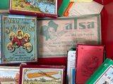 a red suitcase filled with assorted books and cards