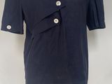the shirt is blue and has buttons on the front