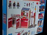a box of playmobil action heroes with a fire station