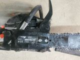 a close up of a chainsaw sitting on the ground