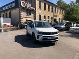the white suv is parked in front of a building with a sign on it