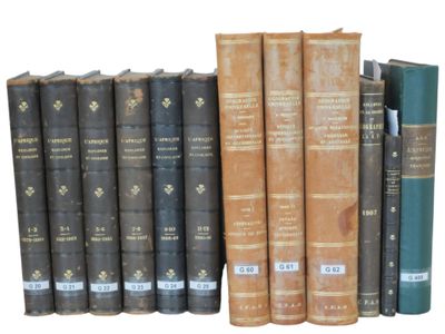several old books are lined up on a shelf next to each other