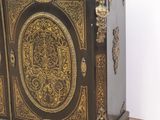 a black and gold cabinet sitting on the floor