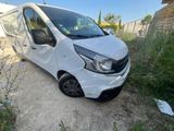 a white van parked on the side of a dirt road