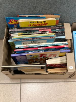 a box full of books sitting on the floor