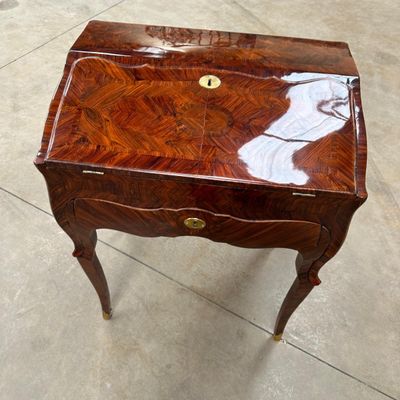 a small wooden table with a drawer on top of it