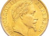a close up of a gold coin on a white surface