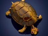 an image of a turtle broochle with a pair of shoes on it ' s feet