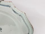 a blue and white plate with a flower design on it