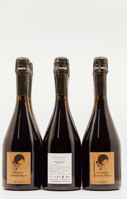 three bottles of wine sitting next to each other on a white surface
