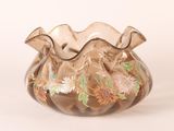 a glass vase that has a floral design on it