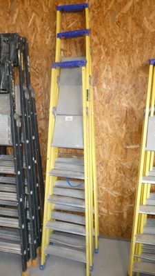 three ladders that are next to each other in a room