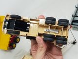 a person holding a toy truck in their hand