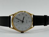 an image of a gold and black watch on a white background