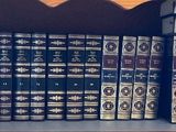 a lot of books that are on a shelf