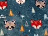 a blanket with a pattern of animals and trees on it