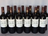 six bottles of wine are lined up in a row on a table