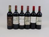 six bottles of wine are lined up on a white surface