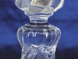 a clear glass vase with a flower on top of it