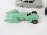 three toy cars that are sitting on a white surface
