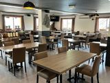 a large dining room with tables and chairs in it