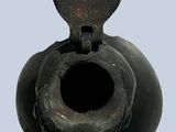 a black vase with a heart shaped hole in it