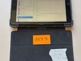 a tablet computer sitting on a table with a sticky note attached to it