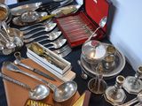 a table full of silverware and silverware on a table